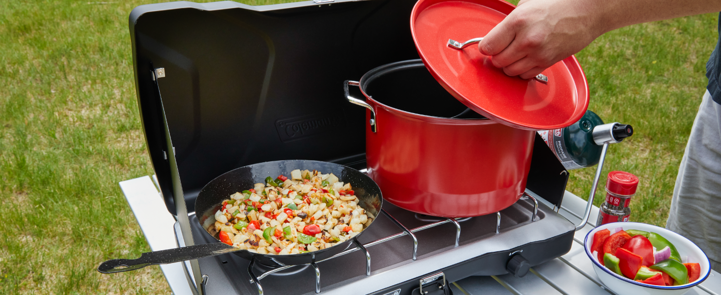 coleman stove grill breakfast pan pot red propane table seasoning bowl grass yard tailgate bbq camp