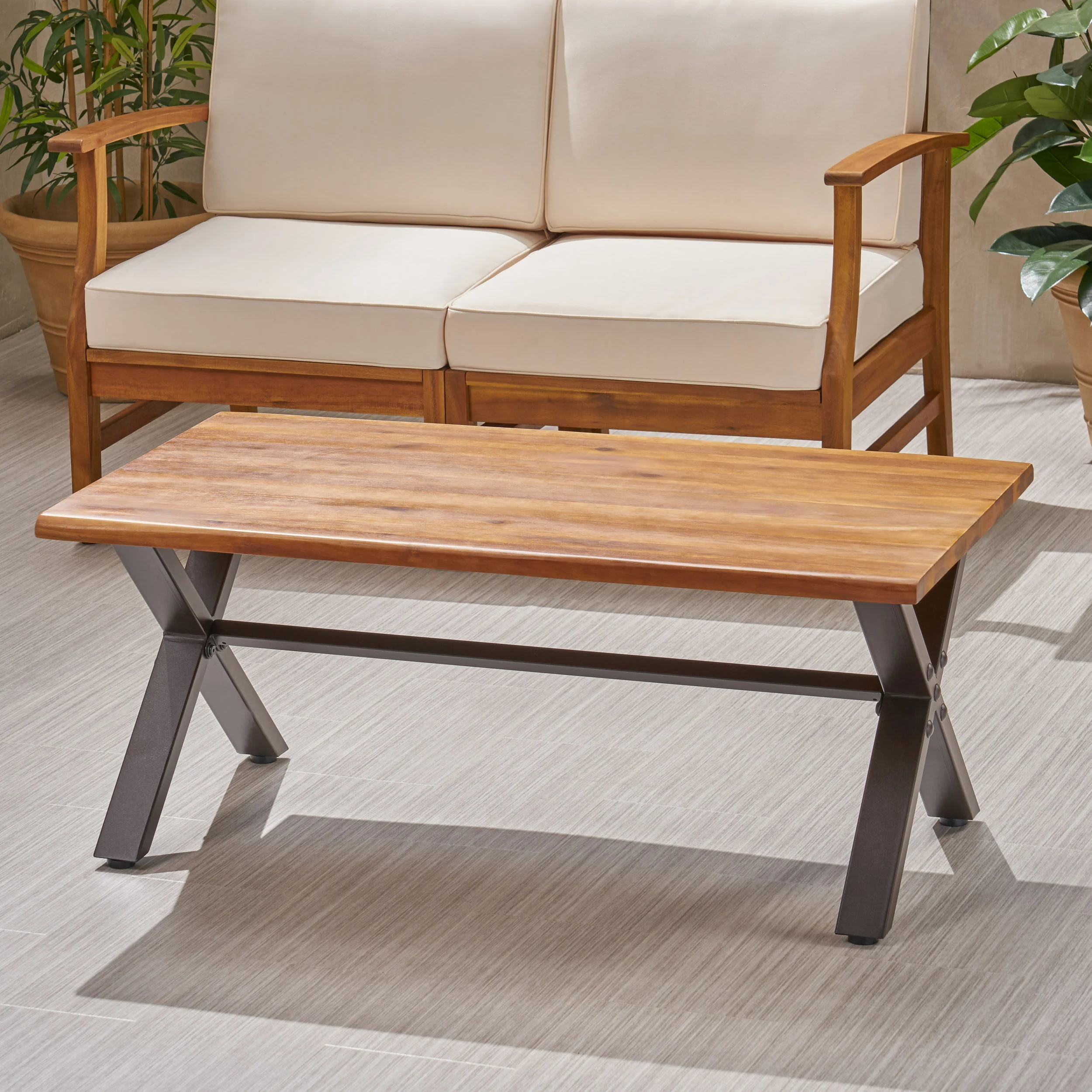 Ishtar Outdoor Farmhouse Teak Acacia Wood Coffee Table with Black X-Frame Legs - furnishings
