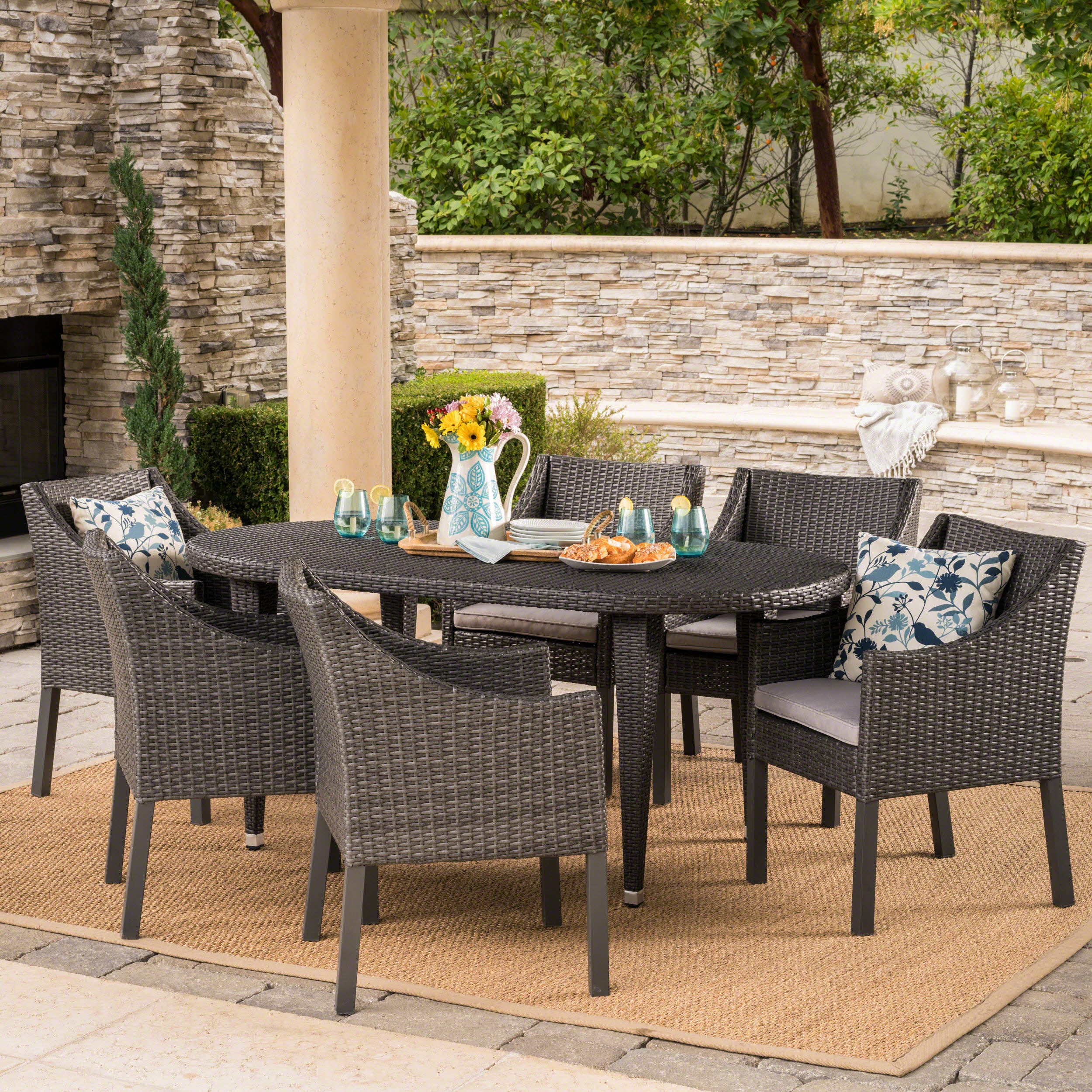 Nicholas Outdoor 7 Piece Wicker Oval Dining Set with Water Resistant Cushions - furnishings